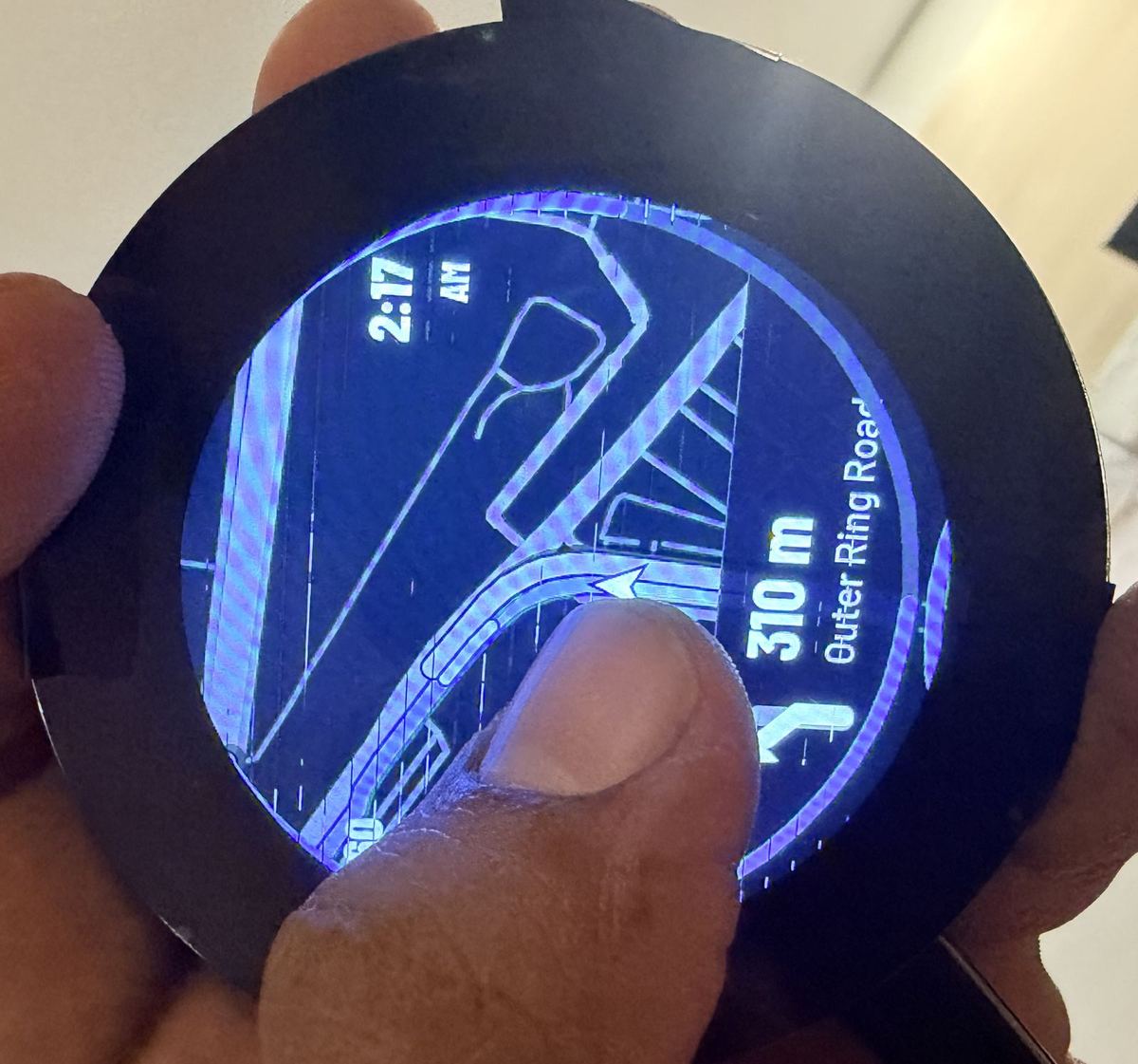 Round screen with dashed marks across the map, clock showing 2:17 AM