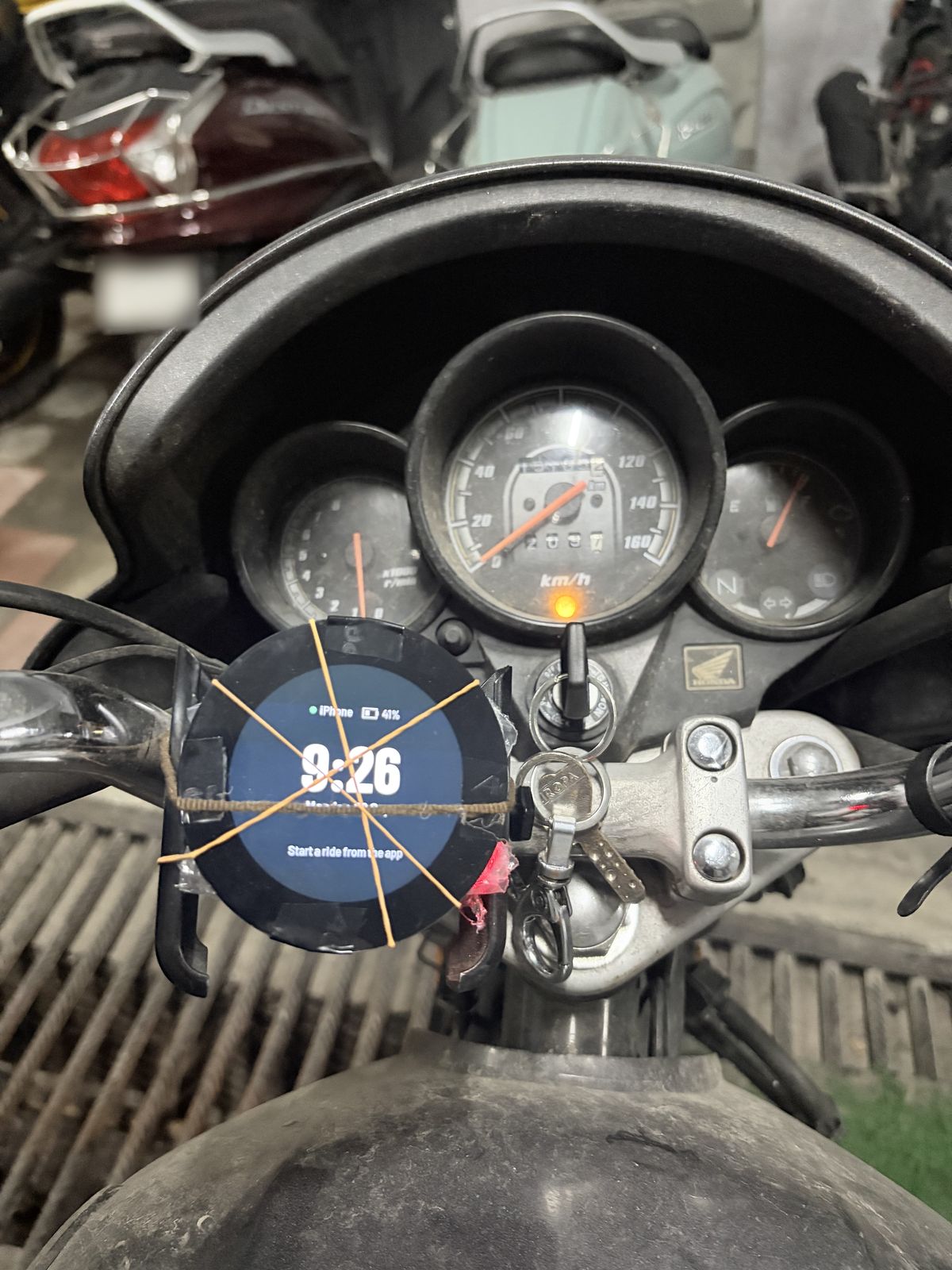 The bare screen rubber-banded to a handlebar for its first ride